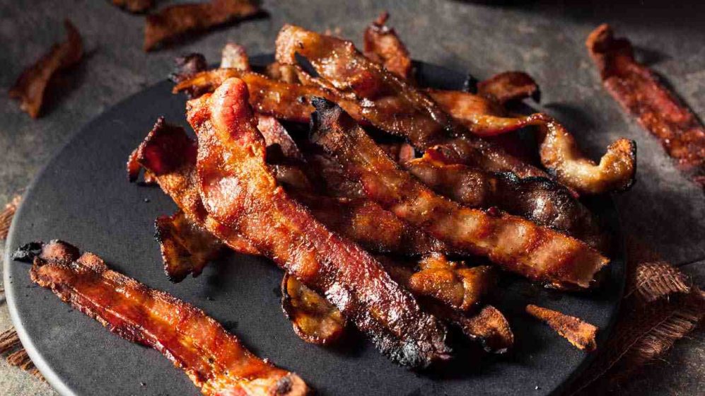 How is bacon made from a pig?