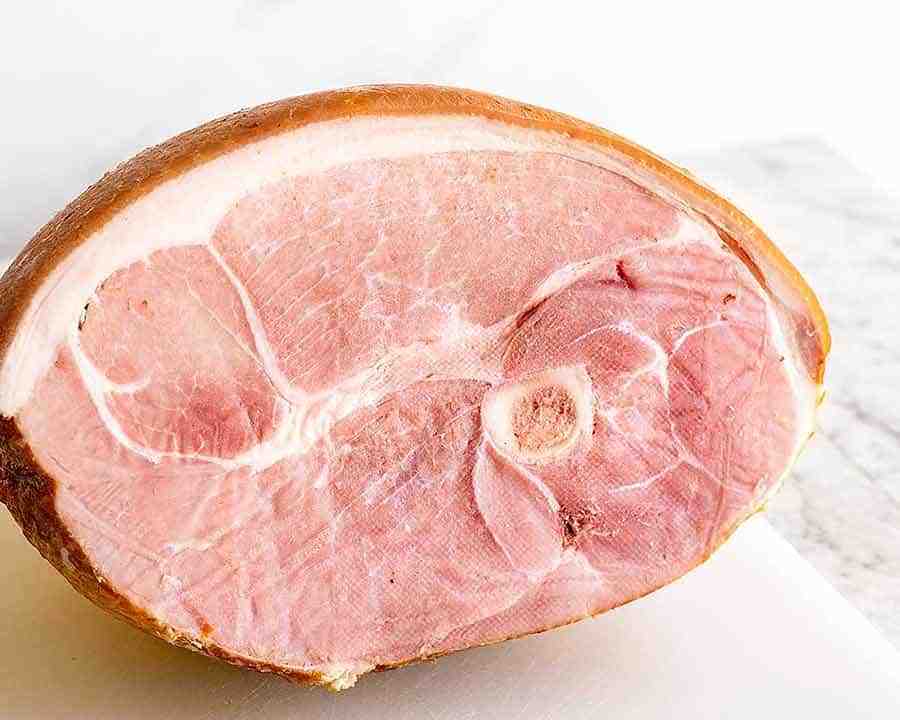 How do you cut a ham before cooking?